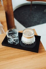 Dirty coffee on a black wooden tray