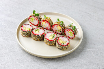 Japanese sushi tempura maki crab meat and tobiko roll on slate. Japanese traditional fusion food style, restaurant menu