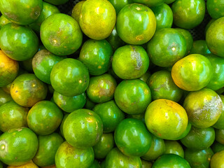 Pile of Glossy Green Oranges with Natural Yellow Hints