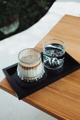 Delicious coffee in a glass placed on a coffee machine