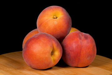 Close-up image of peach fruit on black background.