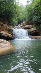 Crystal-clear waterfall cascading into a serene pool, vibrant and untouched nature