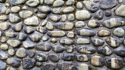 Stone wall built from natural stone washed by rain