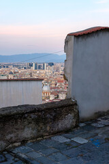 City View of Naples Through Gap in Stone Wall