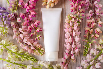 cosmetic moisturizer cream bottle tube and lupine flowers a lot. Shampoo, gel, skincare, facial...