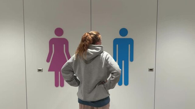 Unhappy sad upset young man with fat on his stomach, worried about body fat touching belly standing at home near closet