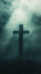 Silhouette of a cross surrounded by mist