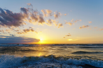 Seascape at sunset. Bright sundown on the sea shore. Sunset on the Baltic Sea.