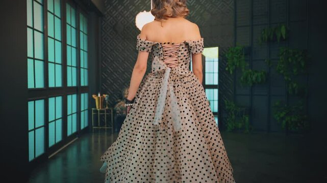 Blonde hair retro lady beauty woman pin up walking high heels classic elegant black shoes in luxury room Vintage dress. Girl sexy fashion model back rear view 30s pin-up Marilyn like Monroe old style