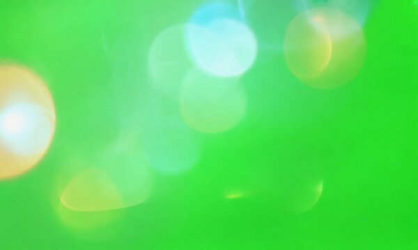 Lens flares on a green screen graphic resource for chroma keying overlay