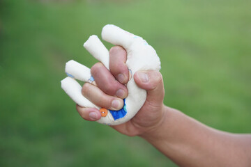 Hand muscle exercises for paralyzed patient by squeezing soft objects stuffed with sponges that fit with fingers locking. Concept, Healthcare for physical therapy to strengthen or recovery weak muscle