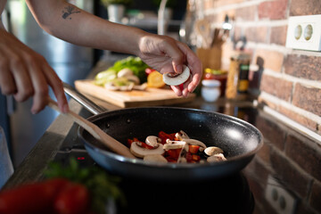 Young woman preparing fresh vegetables in a modern kitchen