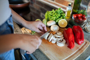 Young woman preparing fresh vegetables in a modern kitchen