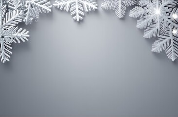 Gray Christmas background with white snowflakes and space for an inscription.