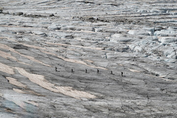 6 walkers in silhouette crossing a glacier in Chamonix