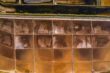 Salt pans divided into sections with seawater on Pag Island. High-quality sea salt production using...