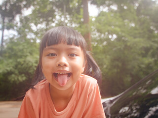 Sunlit Siblings' Playful Car Adventure