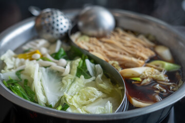Hot pot with two types of soup, clear and shabu soup. with vegetable and meat