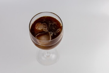 glass with cold iced coffee on a white background