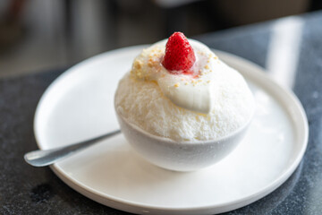 Shaved ice or Bingsu with strawberry on top, served in a bowl