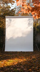 Create a portrait studio background image. The background is a large white panel on top of another white panel, placed in the autumn and winter outdoor environment