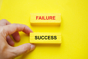 Success and Failure concept; hand select success wooden block; Business achievement