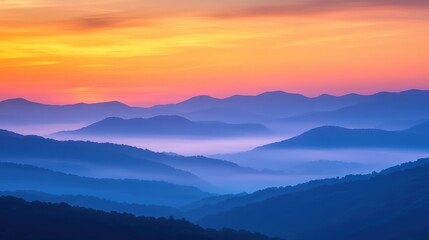 Obraz premium Sunset over the Blue Ridge Mountains, with layers of mist and warm hues filling the sky