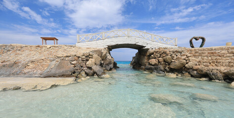 old wooden white bridge on the sea