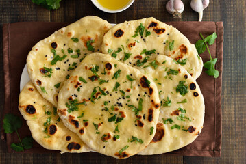 Indian naan bread over wooden background