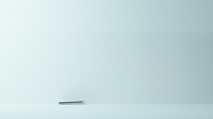 A Silver Metal Object on a Light Blue Surface