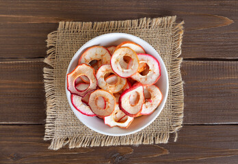  Dried apple rings in white bowl.