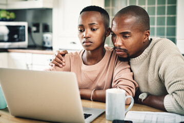 Black couple, home and serious on kitchen counter with laptop on website for insurance options....