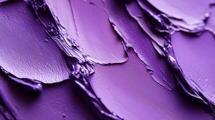A purple paint smear on a wall, with the paint appearing to be a mix of purple