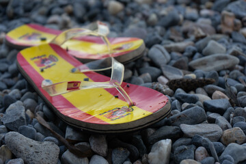 Flip flops with Spain flag in the sea sand