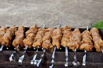 Kitchen. Pieces of pork meat being cooked on the grill
