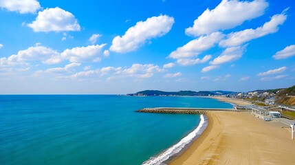 A view of a sandy beach with a body of water and a pier