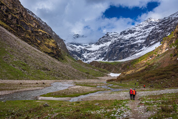 Trekkers with backpack traversing Rupin pass trail, It is full of diversity from majestic Himalayan...