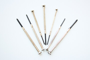 Set of seven long screwdrivers isolated on white background. Tools and equipment for home and industrial repair or maintenance services.