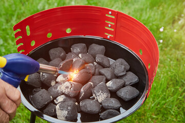 heating the grill with brackets with charcoal. close up