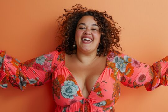 Beautiful plus size hispanic woman is laughing with open arms