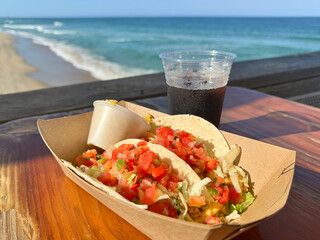 Fish tacos and a soda pop, at an outdoor restaurant, overlooking the Atlantic Ocean in the sunshine