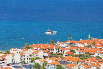 Fototapeta premium view of town and boat on the sea from hill in pefkochori, greece