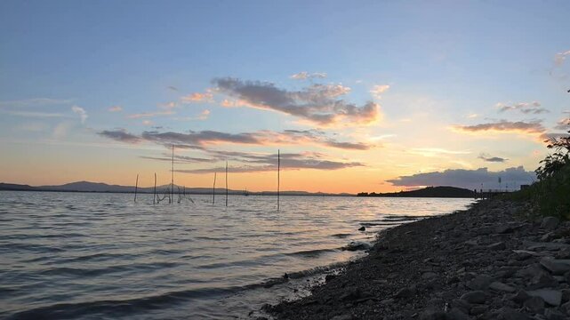 Lago Trasimeno, Umbria, Italia. Tramonto con reti da pesca in acqua