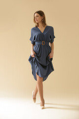 Serie of studio photos of young female model in soft cotton denim midi dress.