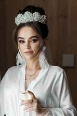 Elegant Bride with Sparkling Tiara and Flawless Makeup Holding Champagne Glass on Wedding Morning