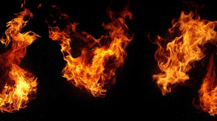 Fototapeta premium Three abstract flames are captured in this image, showcasing the fiery dance of nature. The flames are isolated against a black background, highlighting their vibrant orange and yellow hues. These fla