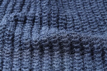 Texture of blue knitted fabric as background, closeup