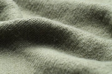 Texture of olive knitted fabric as background, closeup