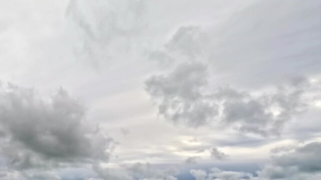 A sky covered with a multitude of clouds. The clouds are mainly white and grey, with some appearing lighter and fluffier than others. They are scattered throughout the image.