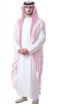 A man elegantly dressed in Saudi Arabias traditional clothing stands confidently